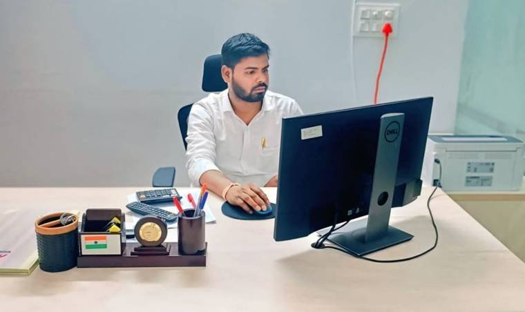 Parupalli Nagaraju, founder of Sri Mokshitha Management and Services, working at his office desk